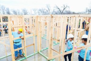 Volunteers building house.