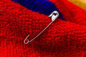 Safety pin in red fabric