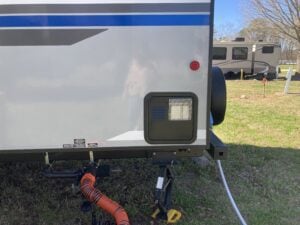 RV bumper with sewer hose storage.