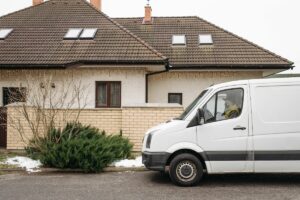 Van RV parked in front of house.