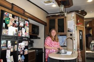 Woman filling pot with water in RV kitchen