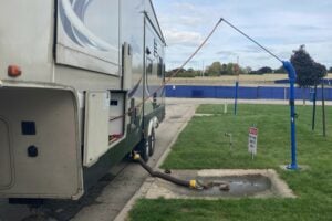RV dump station with flush hose connected.