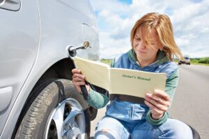 Woman reading owners manual.