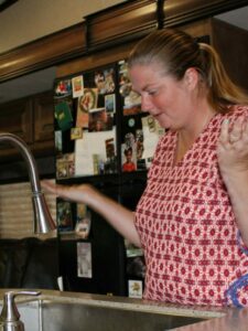 Woman standing above RV sink with no hot water