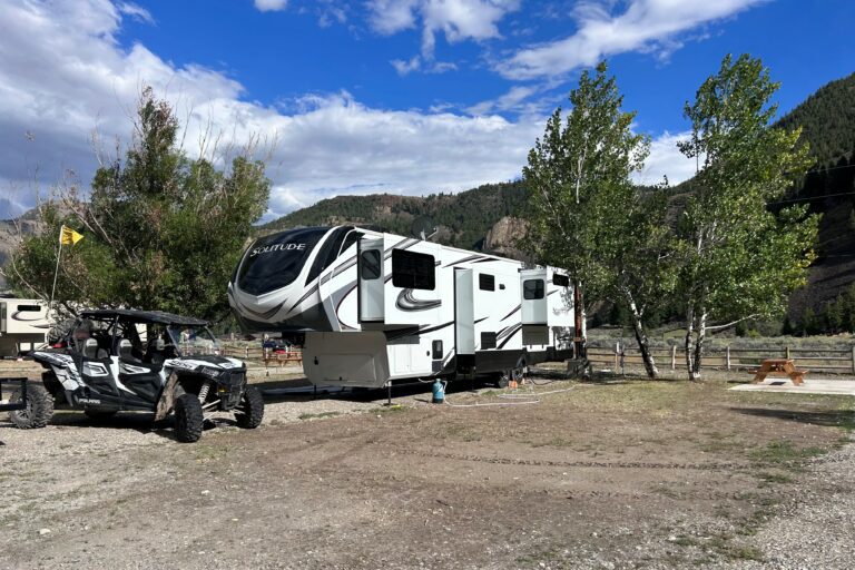 ATV Campground with Fifth Wheel RV Parked in Front of Mountains