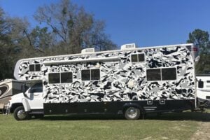 RV wrapped with black and white camo design