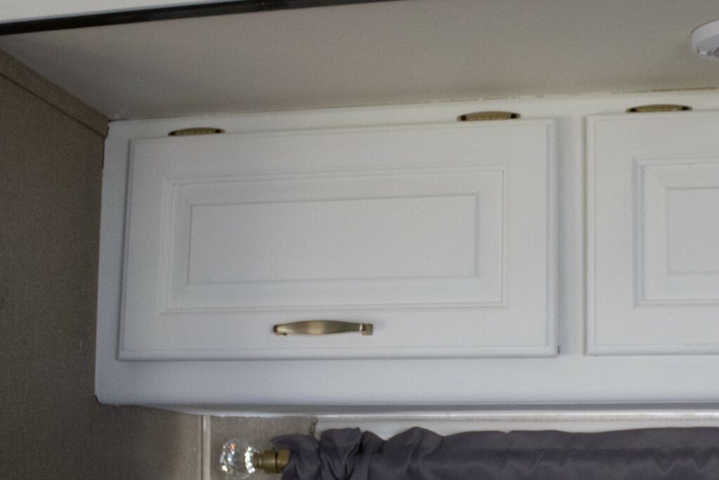 RV kitchen cabinet painted with new hardware.