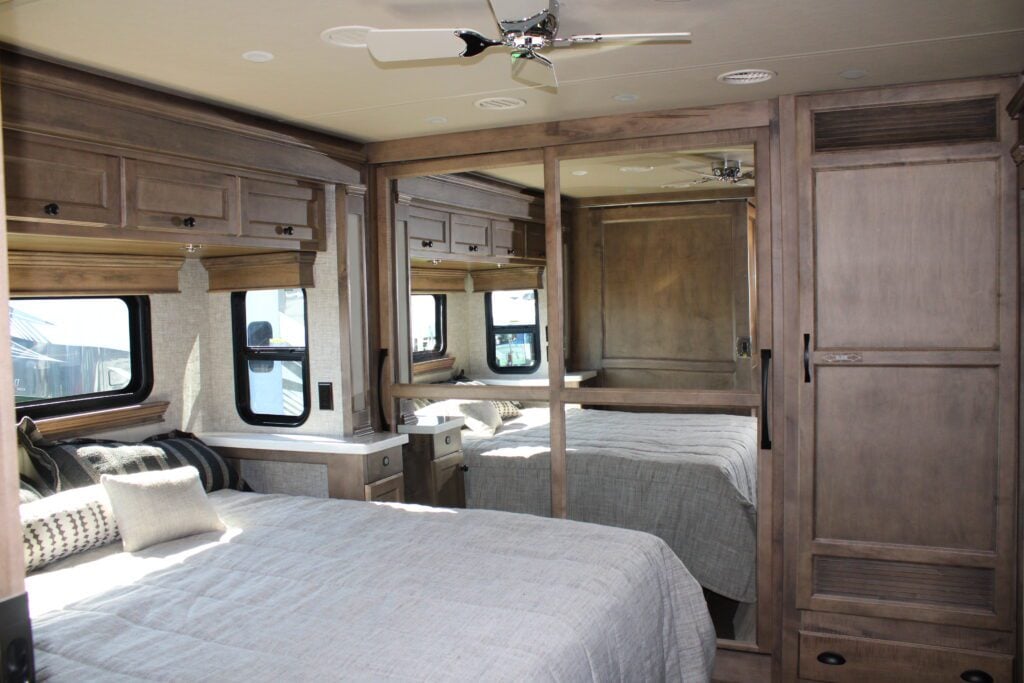 RV bedroom with mirrored closet doors. 