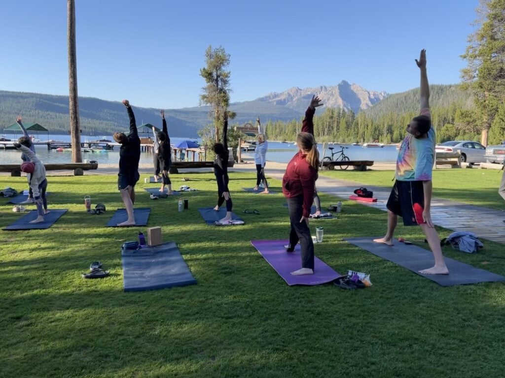 Outdoor yoga class with mountain view.