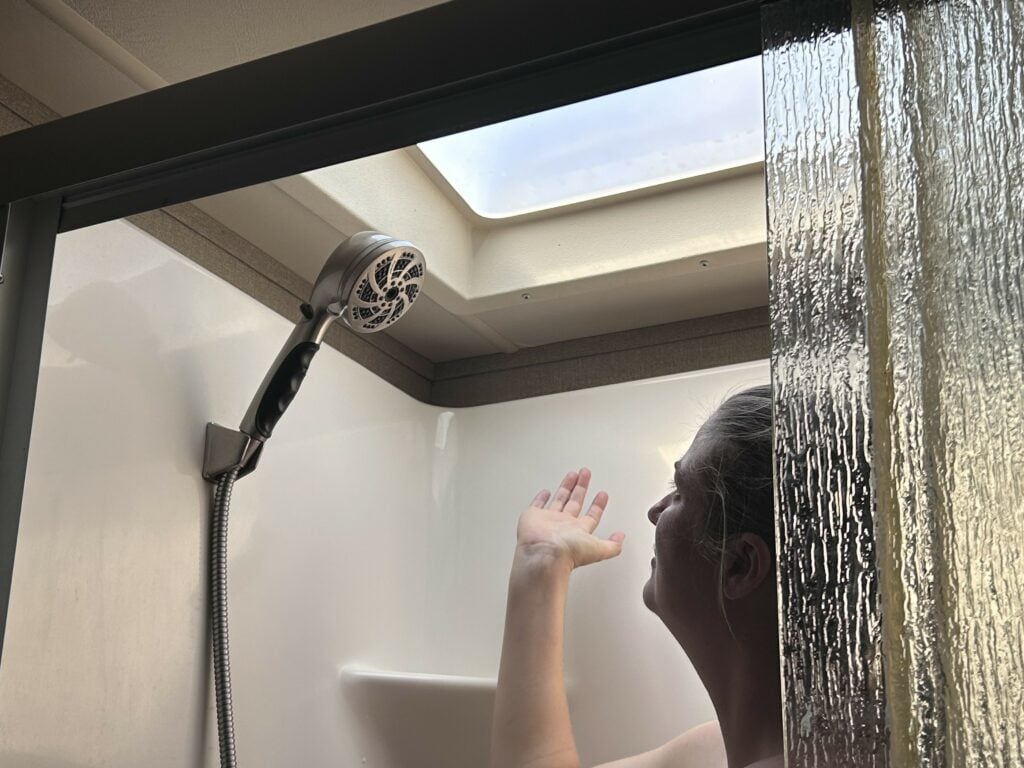 Woman in RV Shower with Water off