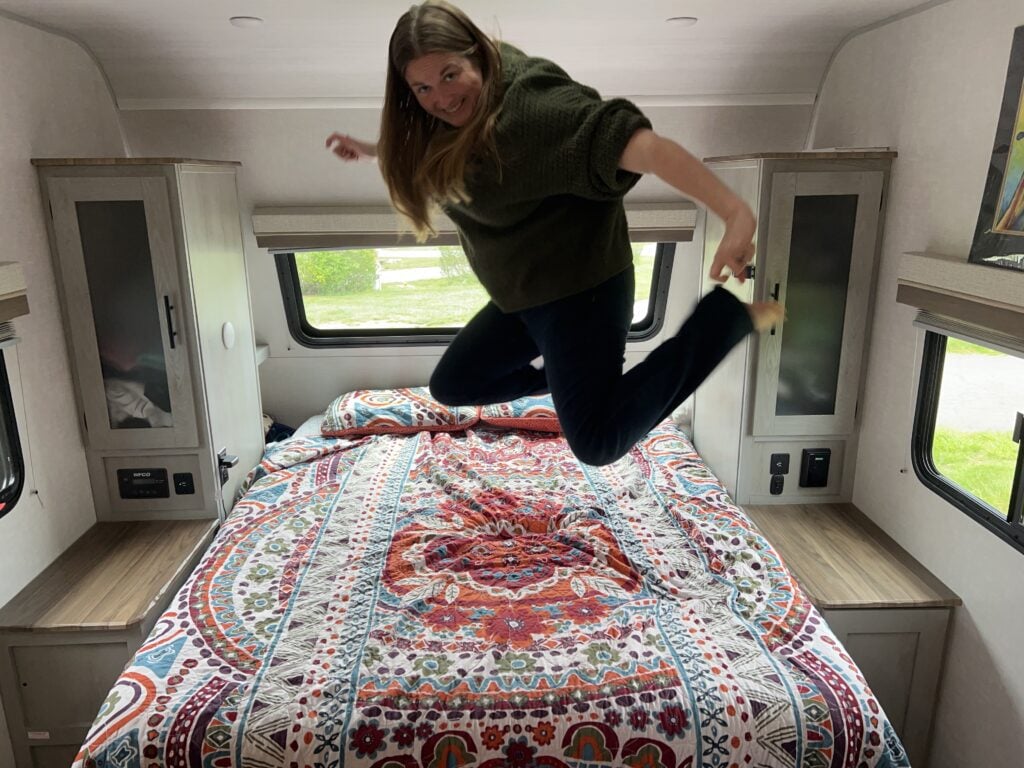 Woman jumping on RV Murphy bed mattress.