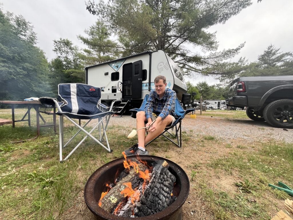 Man roasting banana for s'mores variation