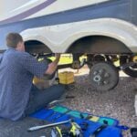 Man replacing RV leaf spring