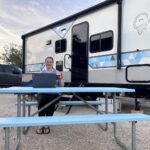 Woman on laptop at RV campsite