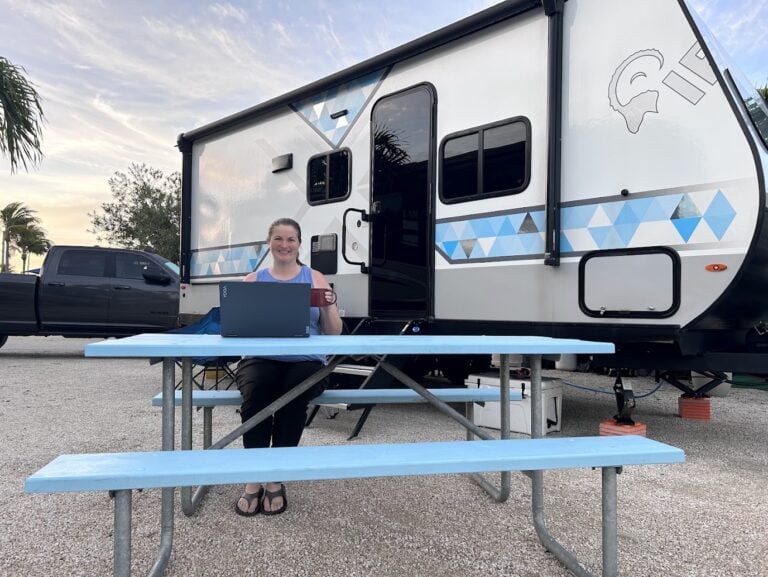 Woman on laptop at RV campsite