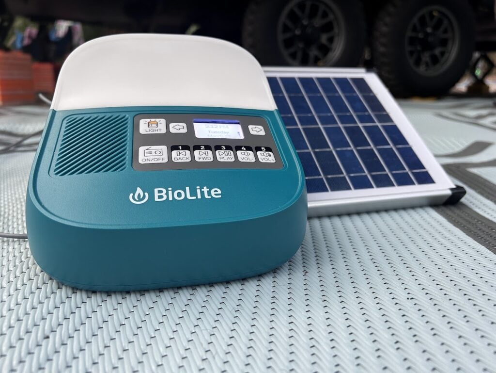 BioLite SolarHome sitting on outdoor rug at RV campsite.