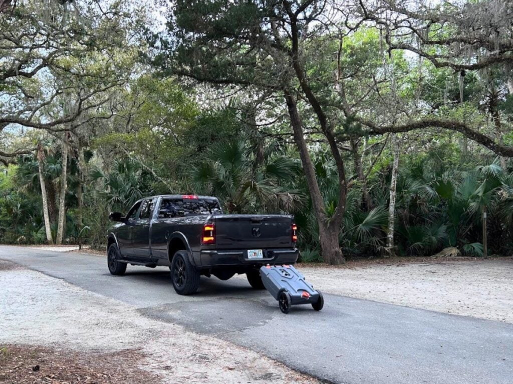 Truck towing portable RV waste tank