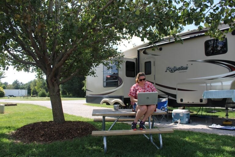 Woman on computer at RV campsite