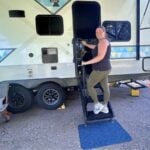 Woman entry RV with upgraded stairs and a door mat.
