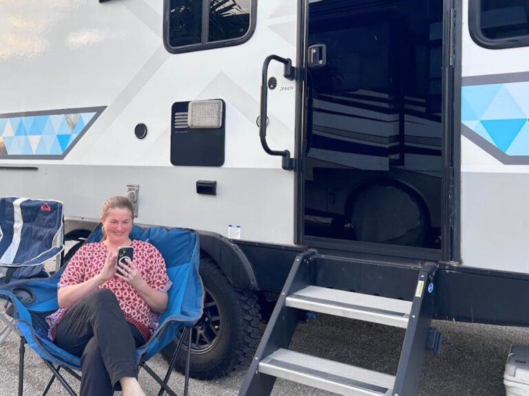 Woman using smartphone at RV campsite