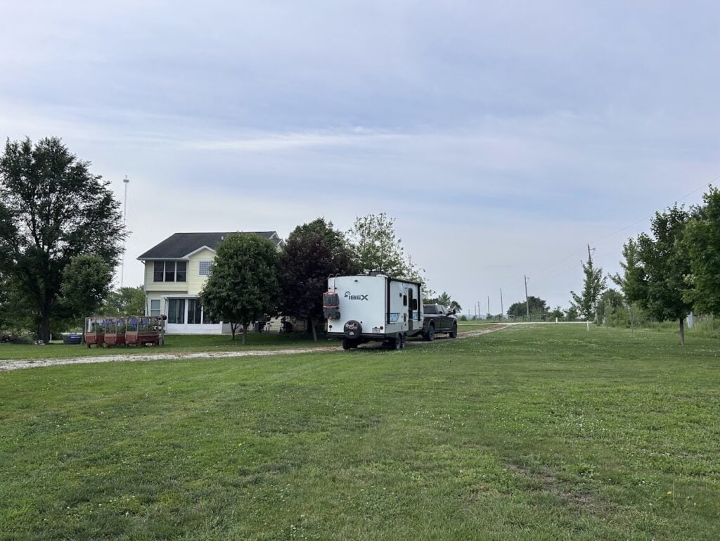 Travel trailer RV driving out of driveway.