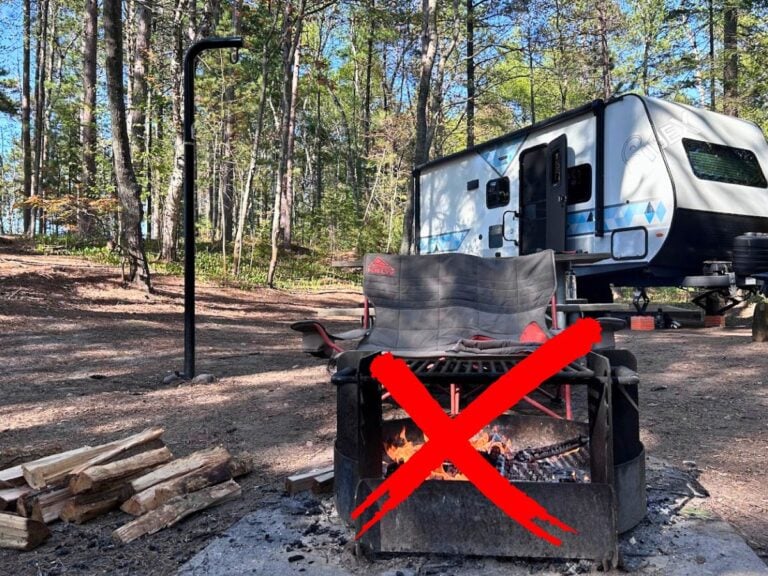 RV campsite with campfire. Red X over campfire.