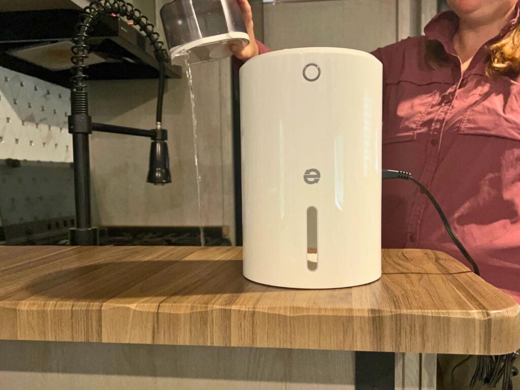 Women emptying RV dehumidifier