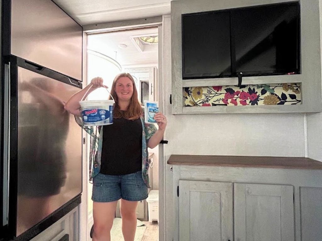 Woman holding RV moisture absorbing bucket