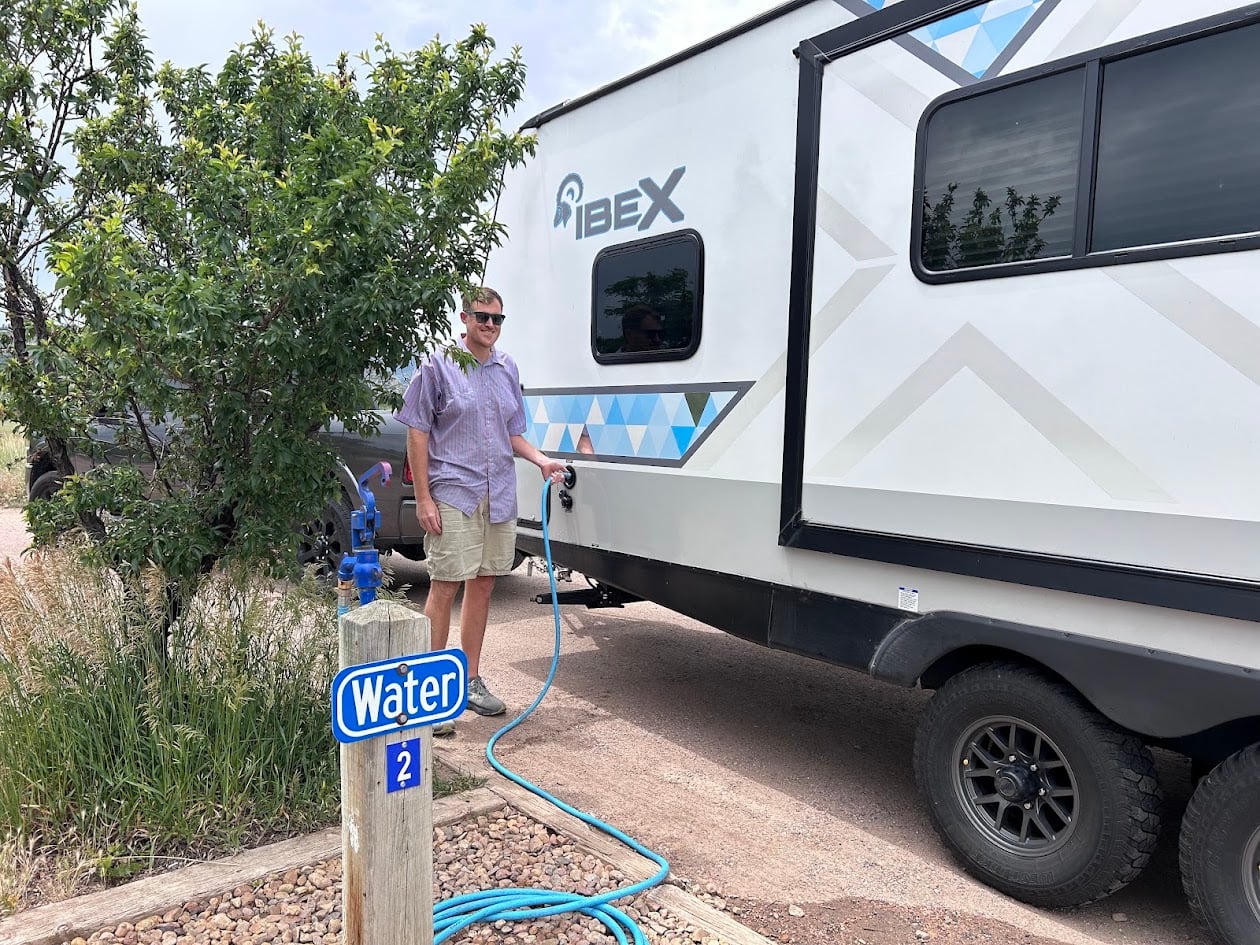 Man filling RV water tank